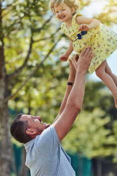 Out for a whole lot of fun. a father bonding with his little daughter outdoors