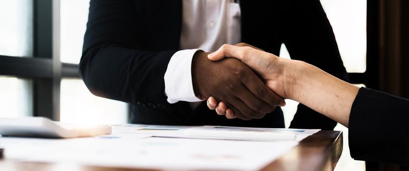 Young business people shaking hands in the office. Finishing successful meeting