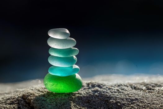 Zen balance stack of sea glass pebbles stones with side light