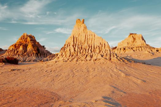 Three sand monuments sculpted by nature stand in the Australian desert