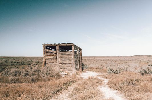 OUtback dunny - toilet - made of rough hewn timbers sits in remote outback Australia