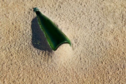 Old bottle stranded on th beach after tide