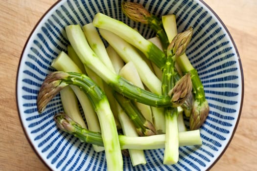 Green asparagus in a bowl before cooking