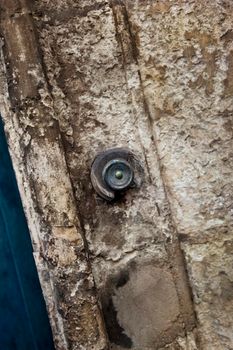 Damaged doorbell on an old stone wall