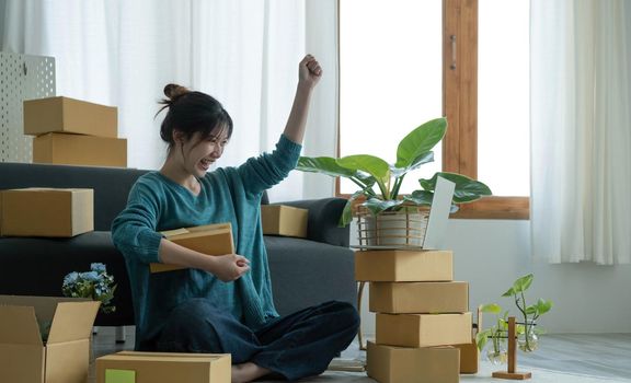 Portrait of Starting small businesses SME owners female entrepreneurs working on receipt box and check online orders to prepare to pack the boxes, sell to customers, SME business ideas online..