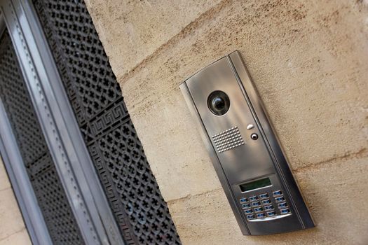 Close up of a modern intercom on a stone facade of a French house