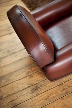 Close up of a leather armchair and wooden floor in a French room