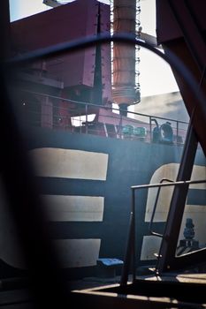 Loading grain into holds of sea cargo vessel in seaport from silos of grain storage. Bunkering of dry cargo ship with grain.