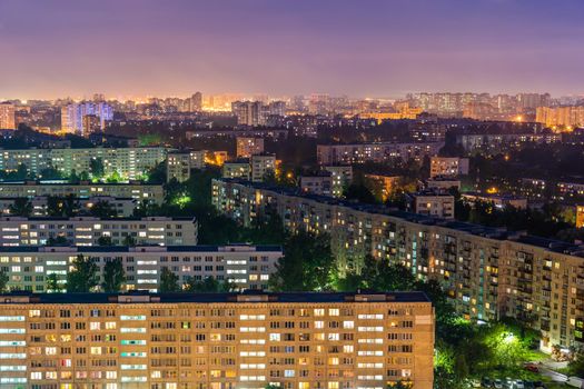 Night colorful windows lights of the high-rise residential building in city sleeping area