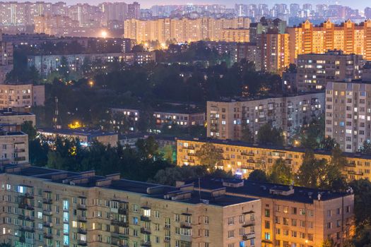 Night colorful windows lights of the high-rise residential building in city sleeping area