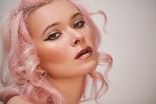 Soft-Girl Style with Trend Pink Flying Hair, Fashion Make-up. Woman Face with Fake Freckles and Rose Hairstyle. Blonde Female Model with perfect Fresh Clean Skin, Blush Rouge