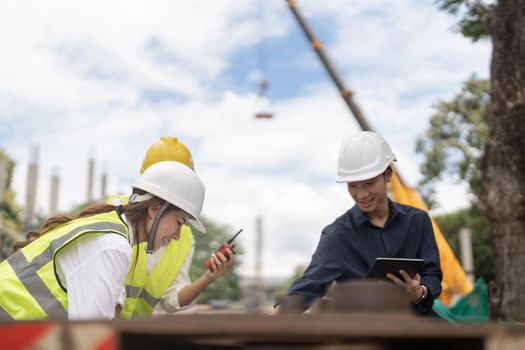 Young construction engineer people working together at the building site place background, industrial engineering concept.