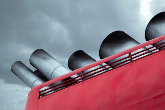 Close up of chimneys of a cruise ship and cloudy sky