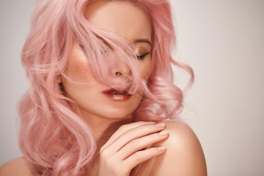 Soft-Girl Style with Trend Pink Flying Hair, Fashion Make-up. Woman Face with Fake Freckles and Rose Hairstyle. Blonde Female Model with perfect Fresh Clean Skin, Blush Rouge