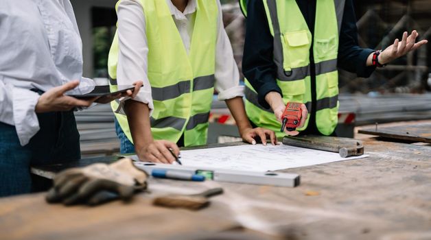 Asian foreman and engineer meeting in house under construction.