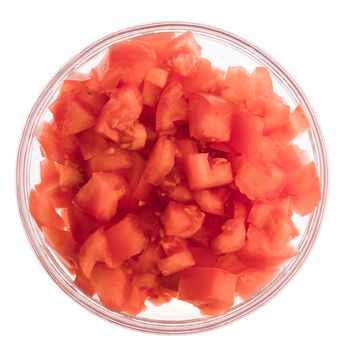 Chopped tomatoes in glass bowl isolated on white and viewed from above.