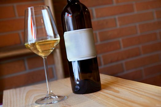 Glass of white wine and bottle in a French cellar