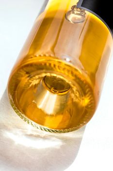 Close up of a bottle of Bordeaux white wine on a table