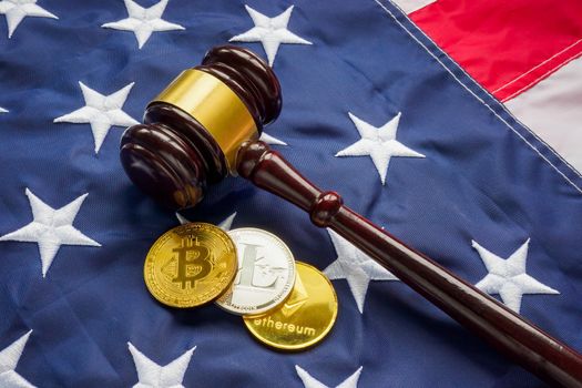 USA cryptocurrency law concept. Coins, flag and a gavel.