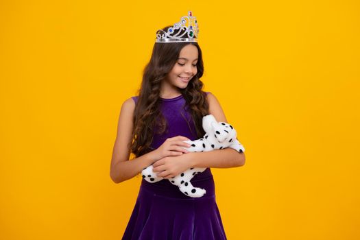 Little queen wearing golden crown. Teenage girl princess holding crown tiara. Prom party, childhood concept. Happy girl face, positive and smiling emotions