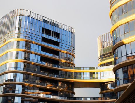 Futuristic square architecture of apartment building. Modern glass high-rise buildings.