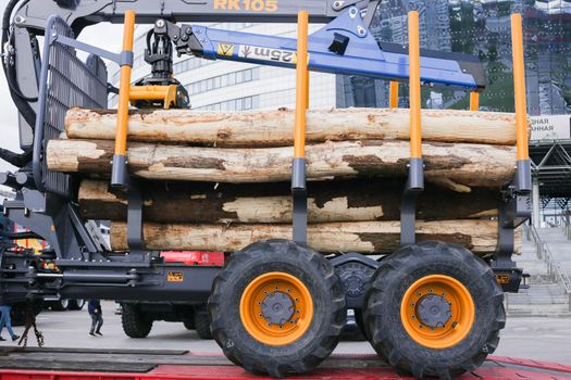 Automobile transportation of lumber. Big truck carrying firewood.. Lumber truck with logs at the exhibition.