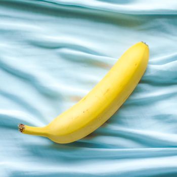 ripe banana on blue background - fresh fruits and healthy eating styled concept, elegant visuals