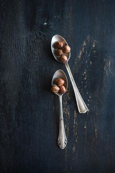 Organic nuts on dark wooden table with copyspace