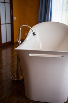 Interior of big bathroom with centre located bath