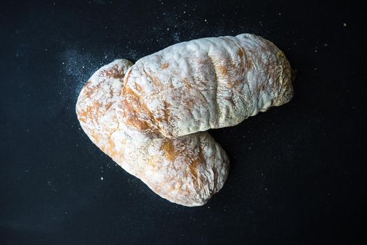 Fresh baked italian bread - ciabatta  on rustic table with napkin