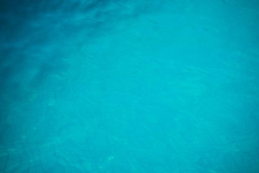 Blue swimming pool rippled water detail as a relax concept