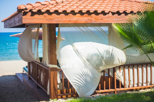 summertime relax on the sand beach with sea waves and beach cabin