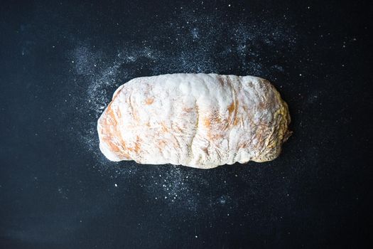 Fresh baked italian bread - ciabatta  on rustic table with napkin