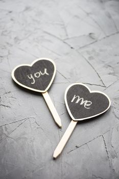 Heart shaped chalkboard with me and you writting on concrete rustic background