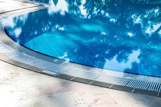 Blue swimming pool rippled water detail as a relax concept
