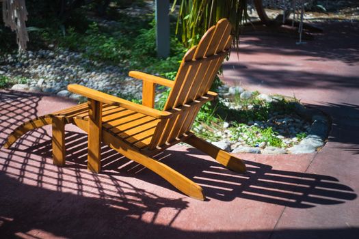 Old styled wooden park bench in a city park