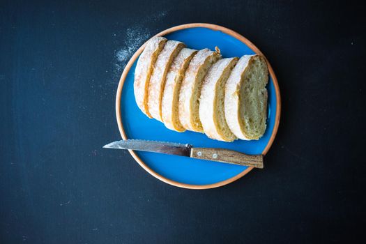 Fresh baked italian bread - ciabatta  on rustic table with napkin
