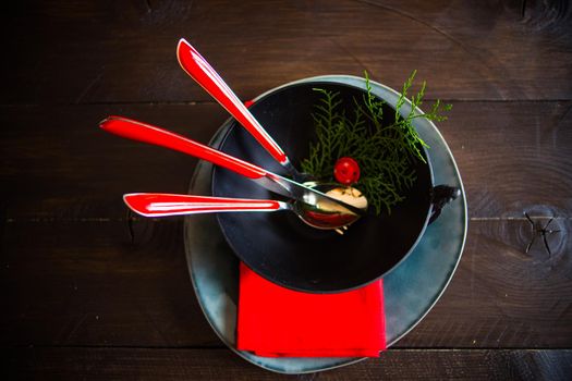 Festive table setting for Christmas dinner on dark rustic table with copyspace