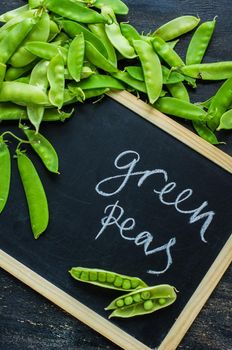 Organic green peas on rustic background