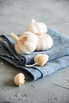 Fresh raw garlic head on rustic board