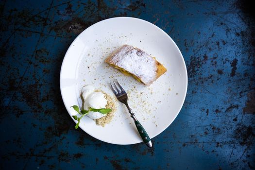 Fresh baked apple viennes strudel with ice cream and mint