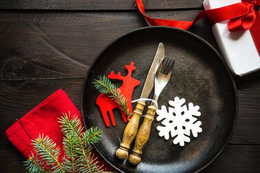 Festive table setting for Christmas holiday dinner with vintage flatware and decoration