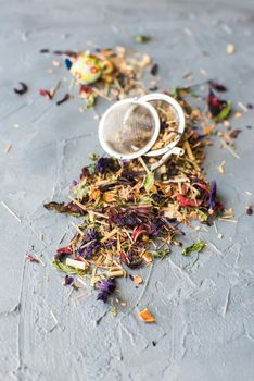 Dry tea leaves with flowersand fruits on wooden background with copyspace as a organic tea concept