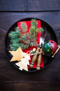 Festive table setting for Christmas holiday dinner with vintage flatware and decoration