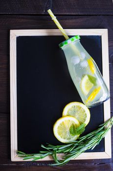 Detox drinks with mint, lemon, watermelon and rosemary in a vintage bottles