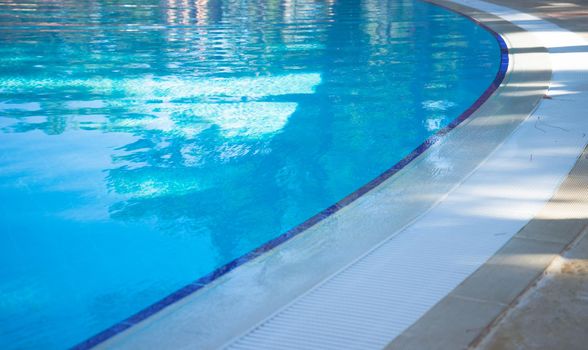 Blue swimming pool rippled water detail as a relax concept