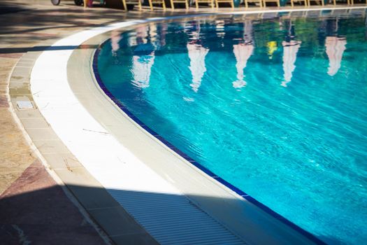 Blue swimming pool rippled water detail as a relax concept