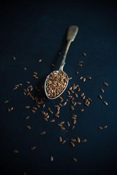 Organic food concept with flax seeds on dark wooden background