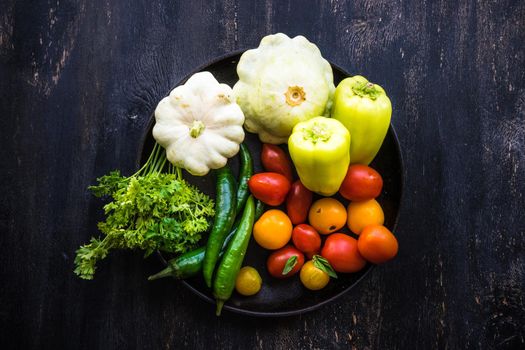 Healthy food concept with  fresh organic vegetables as a ingredients for salads on dark wooden table