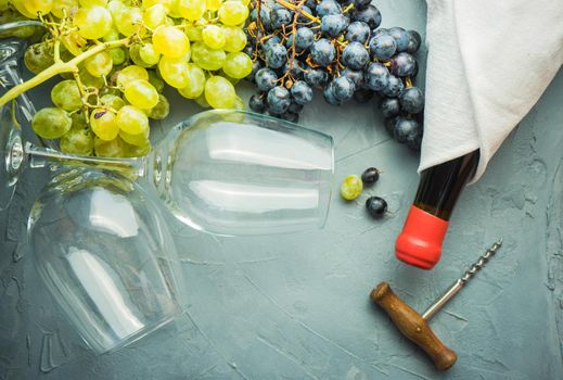 Organic ripe grape and vintage corkscrew on rustic background as a wine concept